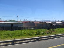 As we merged onto the highway out of the Cape Town Airport we were greeted by a massive township and an informal settlement. This is a photo of the former.